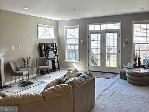 a living room with furniture and a floor to ceiling window