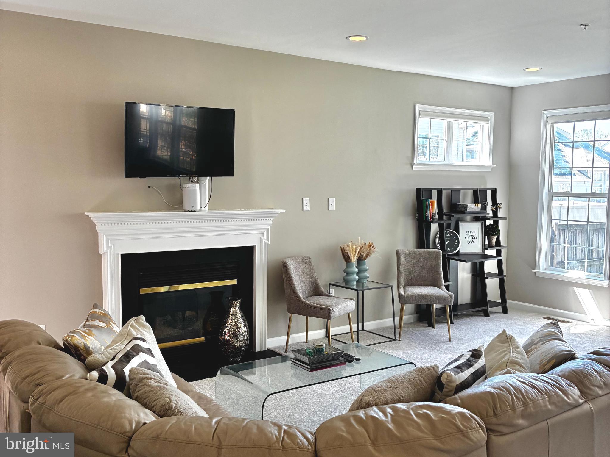 14301 Lightfoot Street Accokeek, MD 20607 - Photo 7 of 32 a living room with furniture a flat screen tv and a fireplace