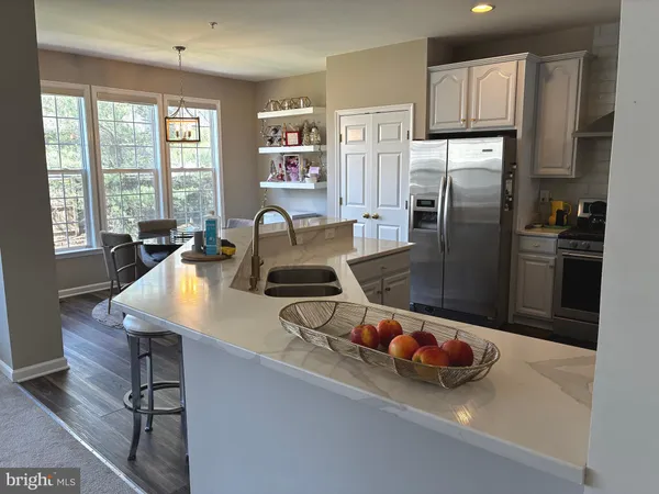 a kitchen with a refrigerator and a sink
