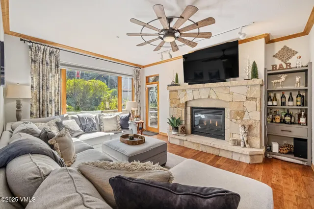 a living room with fireplace furniture and a flat screen tv