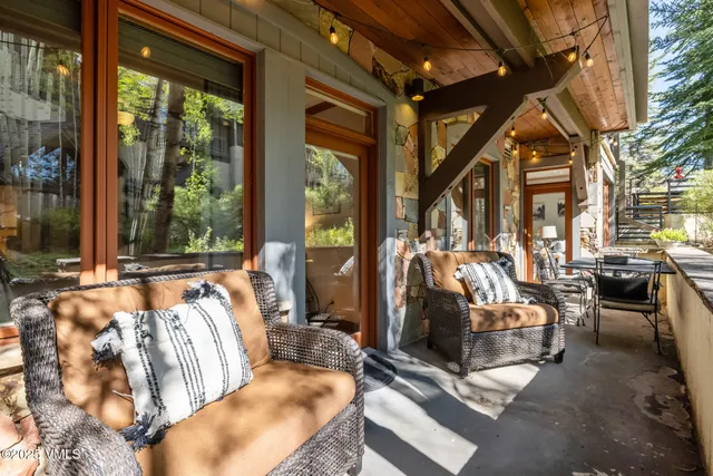 a bedroom with furniture and large windows