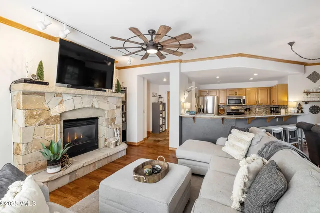 a living room with furniture a flat screen tv and a fireplace