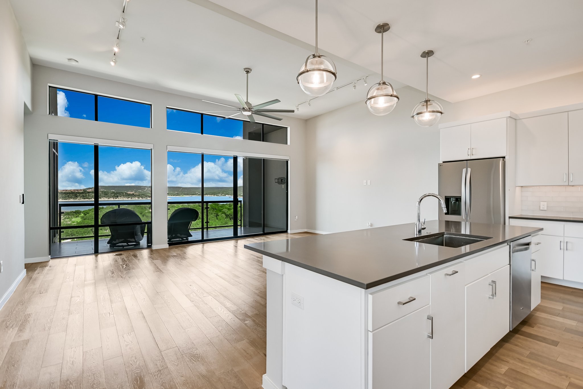 5921 Hiline Road, Unit 1501 Austin, TX 78734 - Photo 36 of 38 a kitchen with stainless steel appliances granite countertop a sink a stove and a wooden floors