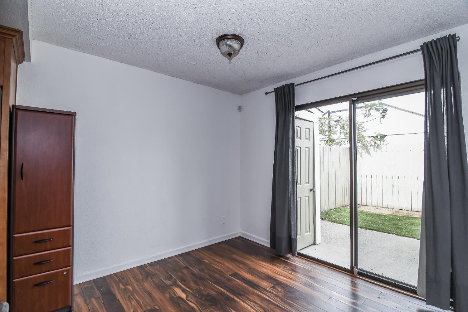 1139 Rivara Circle Sacramento, CA 95864 - Photo 16 of 72 a view of an empty room with wooden floor and a window