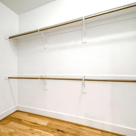 a spacious bathroom with a sink a toilet and a mirror