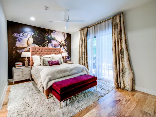 a bedroom with a bed and a painting on the wall