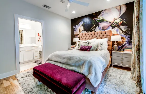 a bed sitting in a bedroom next to a window