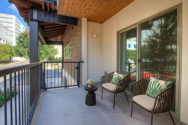 a view of two chairs in the balcony