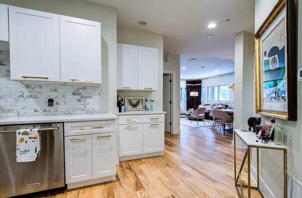 a kitchen with a stove a sink a refrigerator and cabinets