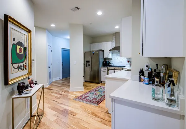 a kitchen with stainless steel appliances granite countertop a refrigerator and a sink