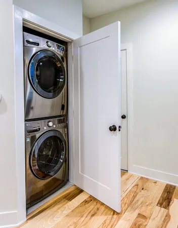 a view of a bedroom with washer and dryer