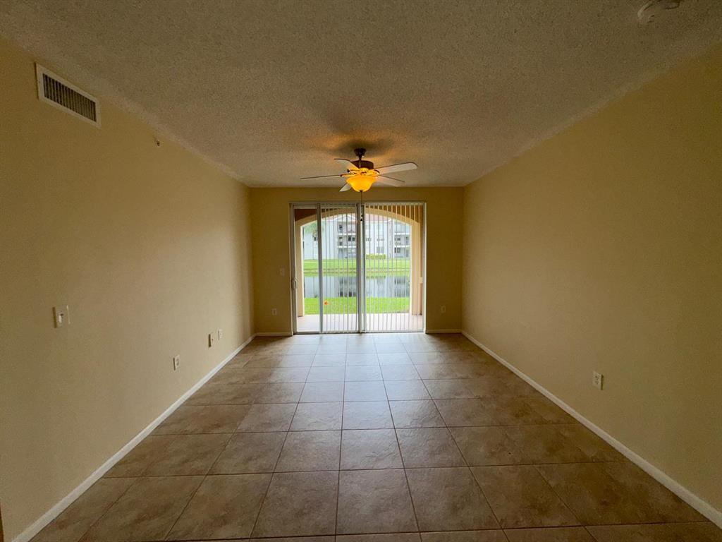 8060 North Nob Hill Road, Unit 106 Tamarac, FL 33321 - Photo 12 of 15 a view of an empty room with a window
