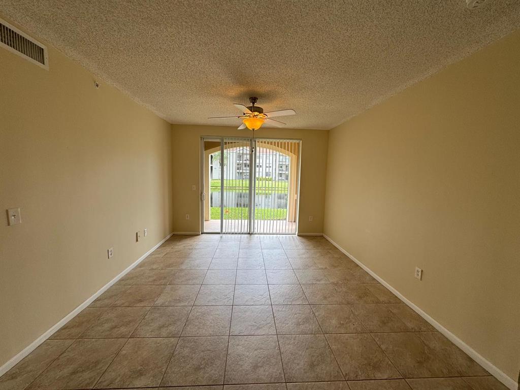 8060 North Nob Hill Road, Unit 106 Tamarac, FL 33321 - Photo 13 of 15 a view of an empty room with a window