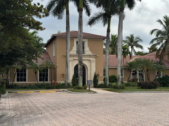 a front view of multiple houses with yard