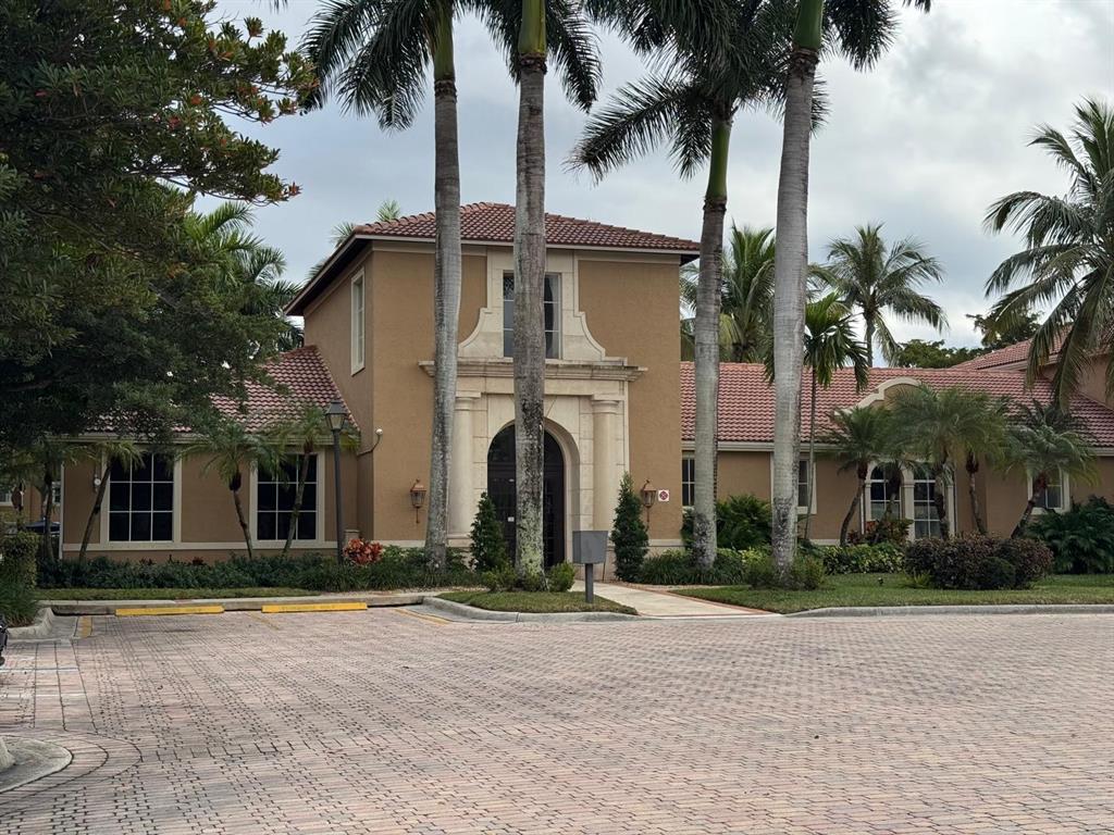 8060 North Nob Hill Road, Unit 106 Tamarac, FL 33321 - Photo 3 of 15 a front view of multiple houses with yard