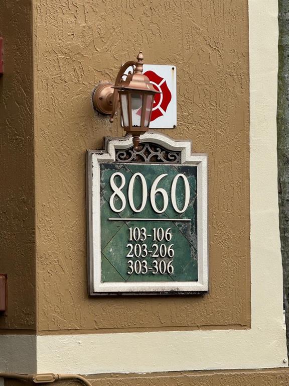 8060 North Nob Hill Road, Unit 106 Tamarac, FL 33321 - Photo 5 of 15 a view of a wooden wall with sign on wall