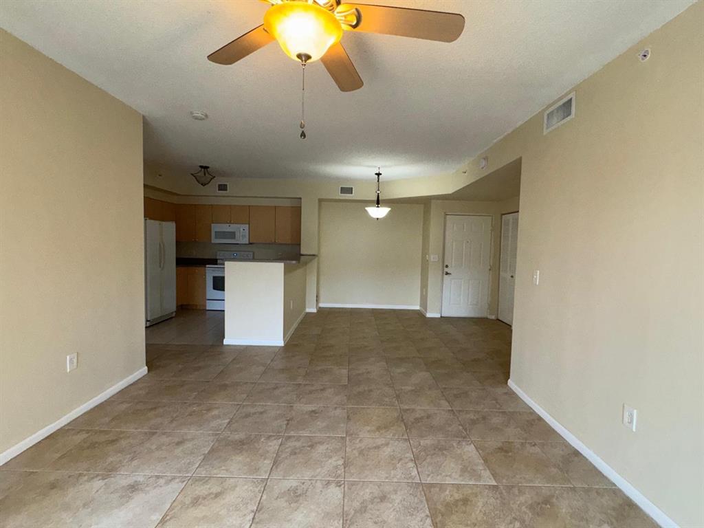 8060 North Nob Hill Road, Unit 106 Tamarac, FL 33321 - Photo 9 of 15 a view of a kitchen with a sink and cabinets