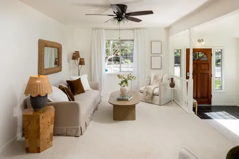 a living room with furniture and windows