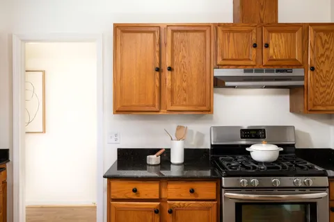 a kitchen with stainless steel appliances granite countertop a sink stove and cabinets