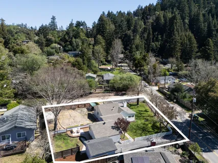 an aerial view of house with yard swimming pool and outdoor seating