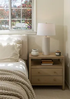 a bedroom with a bed and large window