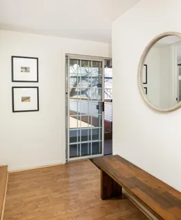 a view of a room with wooden floor and windows