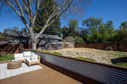 a view of a backyard with sitting area