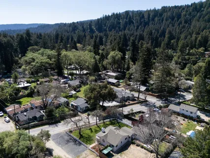 an aerial view of residential house with green space