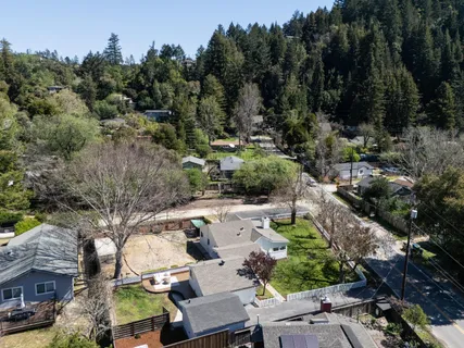 a view of backyard with swimming pool and outdoor seating