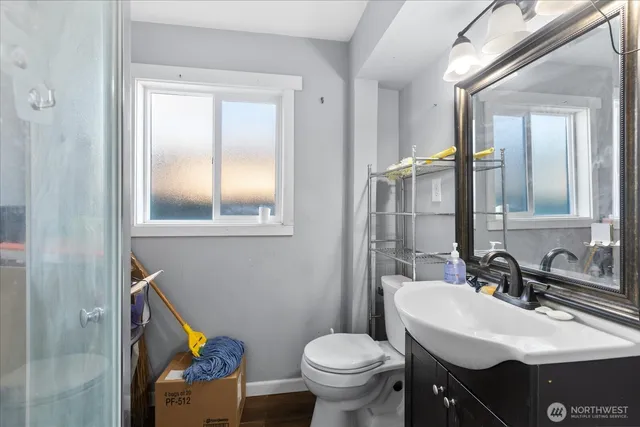 a bathroom with a sink toilet and mirror