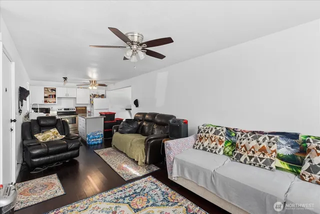 a living room with furniture and wooden floor