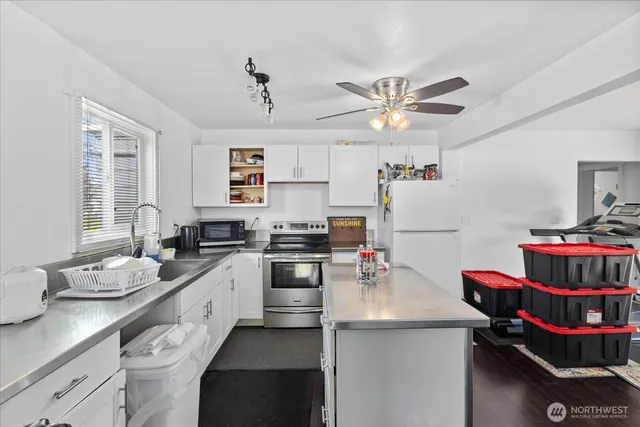 a kitchen with a sink stove and cabinets