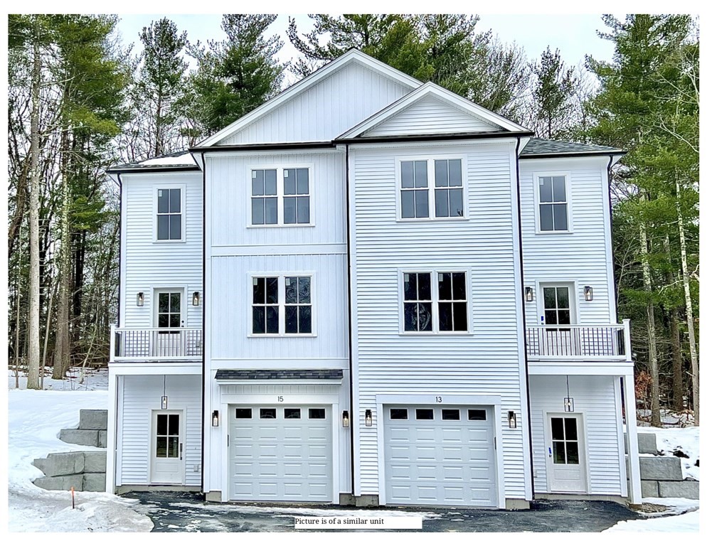 13 Sandy Pond Road, Unit 13 Ayer, MA 01432 - Photo 1 of 5 a view of a big house with wooden fence