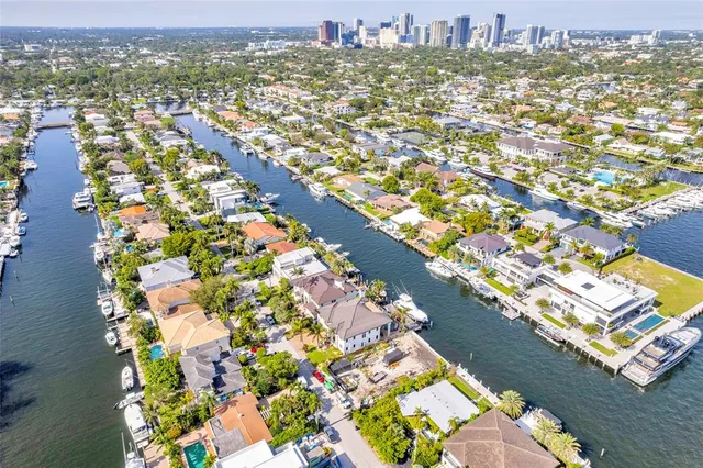 an aerial view of a house with a yard and lake view