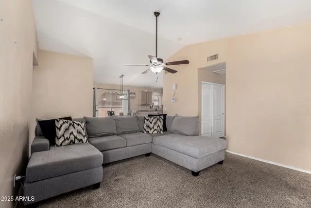 a living room with furniture and white walls