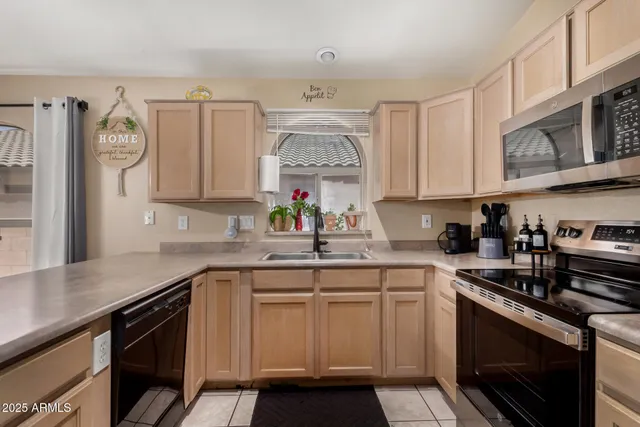 a kitchen with a sink stove and cabinets