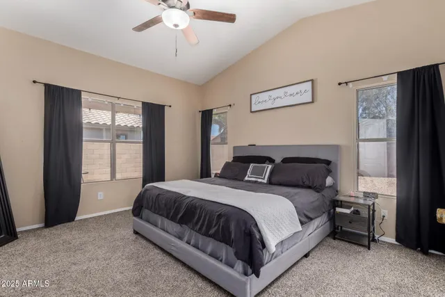 a bedroom with a large bed and a window