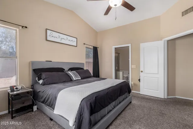 a bedroom with a bed and ceiling fan