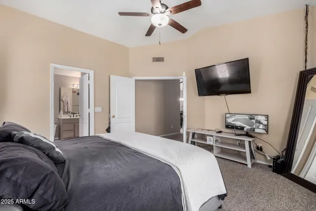 a bedroom with a bed and a flat screen tv