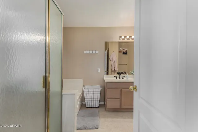 a bathroom with a sink and mirror with toilet