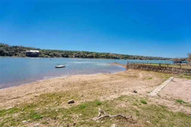 a view of a lake with houses in the back