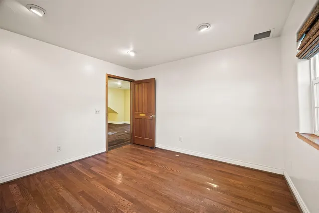 a view of room with window and hardwood floor