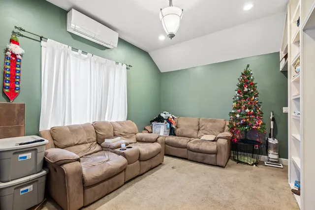 a room with furniture a flat screen tv and a window