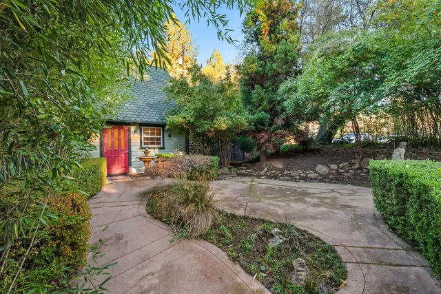 a front view of a house with a garden