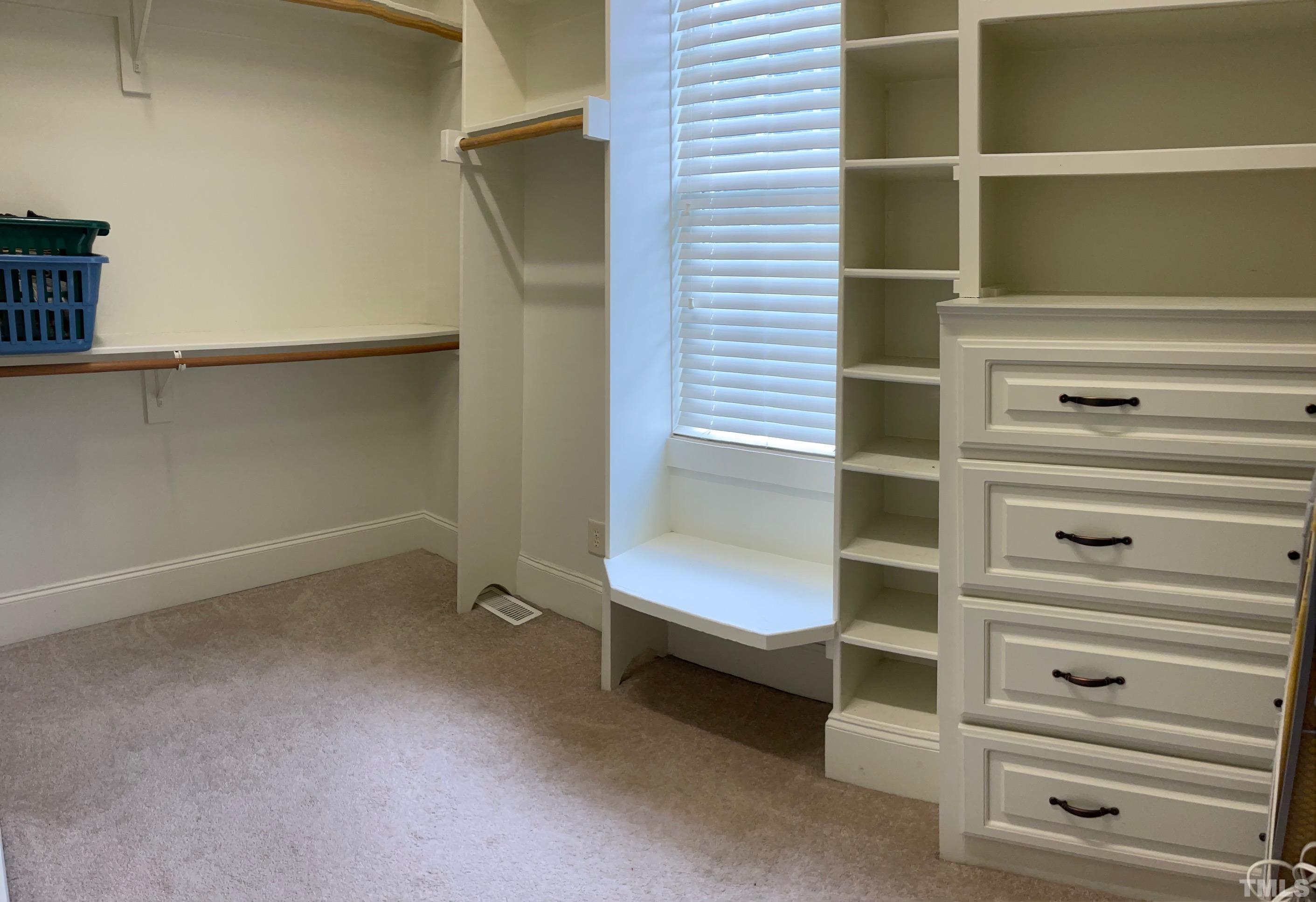 72 Silverside Drive Angier, NC 27501 - Photo 20 of 28 a view of walk in closet with empty racks
