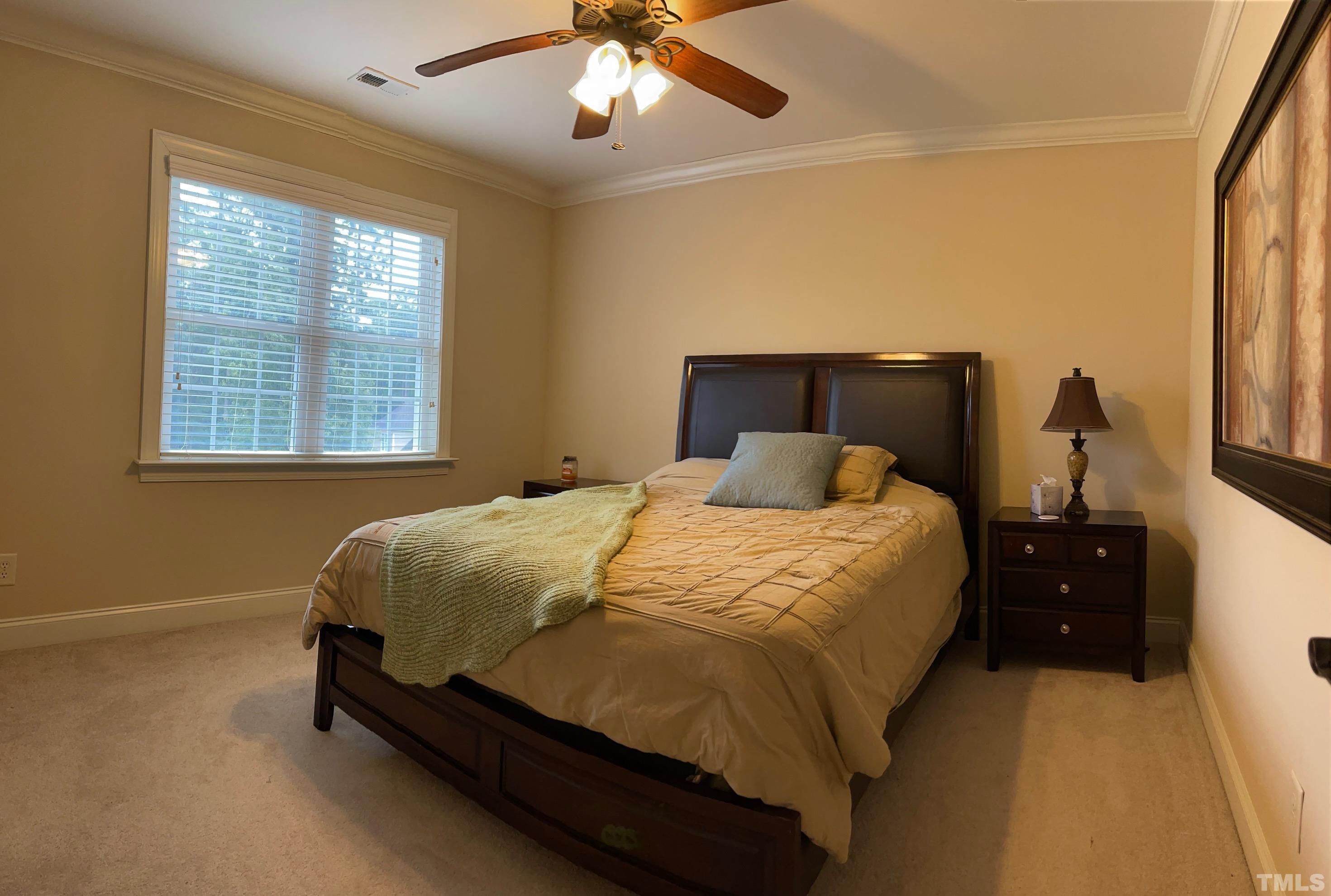 72 Silverside Drive Angier, NC 27501 - Photo 25 of 28 a bed sitting in a bedroom next to a window