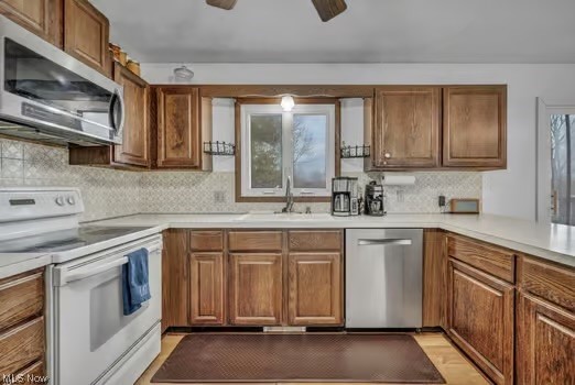 12200 Chamberlain Road Aurora, OH 44202 - Photo 11 of 33 Kitchen with sink, ceiling fan, stainless steel appliances, and a healthy amount of sunlight