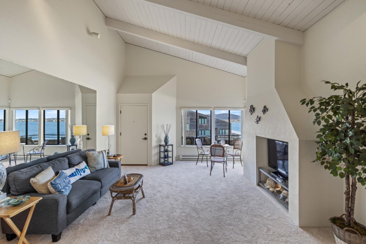 1 Surf Way, Unit 216 Monterey, CA 93940 - Photo 5 of 21 a living room with furniture and a fireplace