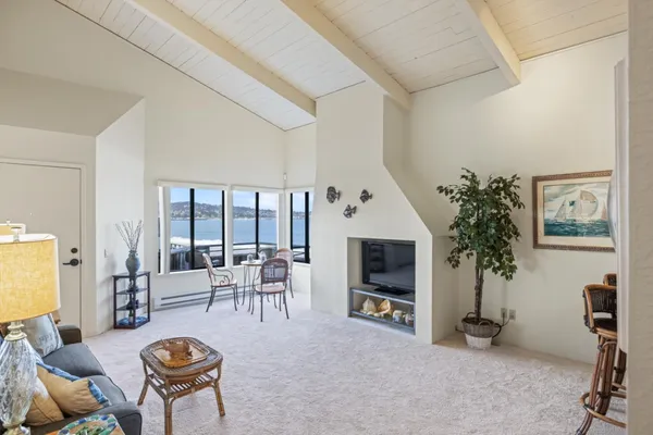 a living room with furniture a flat screen tv and a table
