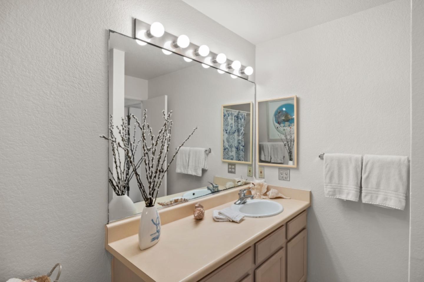1 Surf Way, Unit 216 Monterey, CA 93940 - Photo 10 of 21 a bathroom with a sink and a mirror